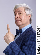 Mature man in suit looking at the camera with finger up. Стоковое фото, фотограф Сергей Пристяжнюк (Serg Zastavkin) / Фотобанк Лори