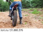 Mototrial rider standing on motorcycle in sand. Extreme sports on motorcross motorcycles. Copy space. Стоковое фото, фотограф Кекяляйнен Андрей / Фотобанк Лори