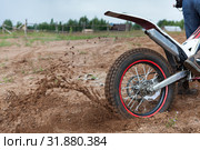 Dirt and sand fly from under rotating wheel of offroad motorcycle, action image, copy space. Стоковое фото, фотограф Кекяляйнен Андрей / Фотобанк Лори