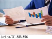 Young male sales analyst in growth concept. Стоковое фото, фотограф Elnur / Фотобанк Лори