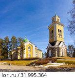 Beautiful view of ancient Lutheran Church whith bell tower in kerimaki of southern Savo province on a sunny spring day. The biggest wooden cathedral in Scandinavia and in the world. Eastern Finland (2019 год). Стоковое фото, фотограф Алексей Ширманов / Фотобанк Лори