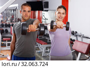 Sporty guy and girl posing with dumbbells. Стоковое фото, фотограф Яков Филимонов / Фотобанк Лори