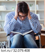 Disabled student studying at home on wheelchair. Стоковое фото, фотограф Elnur / Фотобанк Лори