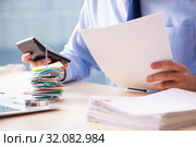 Young male employee in budget planning concept. Стоковое фото, фотограф Elnur / Фотобанк Лори