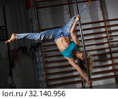 Girl engaged on pylon in semidarkness. Стоковое фото, фотограф Яков Филимонов / Фотобанк Лори