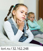Offended girls sitting apart at home. Стоковое фото, фотограф Яков Филимонов / Фотобанк Лори