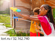 Action image of girl shoot with water gun in game. Стоковое фото, фотограф Сергей Новиков / Фотобанк Лори