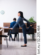 Two employees doing sport exercises in the office. Стоковое фото, фотограф Elnur / Фотобанк Лори