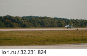 30 AUGUST 2019 MOSCOW, RUSSIA: Russian Air Force - grey reactive fighter jet landing and slows down on the runway - hot air around. Редакционное видео, видеограф Константин Шишкин / Фотобанк Лори