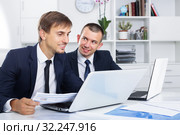 two smiling men coworkers working in firm office. Стоковое фото, фотограф Яков Филимонов / Фотобанк Лори
