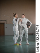 A portrait of two young women fencers laughing. Стоковое фото, фотограф Константин Шишкин / Фотобанк Лори