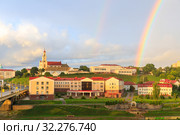 Panoramic view of the city of Grodno, the embankment, the Neman river and the old city. Autumn evening, the city in the sunshine against a background of dark clouds and a rainbow. Стоковое фото, фотограф Mikhail Starodubov / Фотобанк Лори