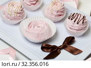 Aerial pink cherry marshmallows. Different shapes and sizes. Sprinkled with dextrose. Garnished with Chocolate. Стоковое фото, фотограф Vadzim Yakubovich / Фотобанк Лори