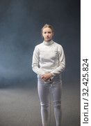A young woman fencer standing with a sword down. Стоковое фото, фотограф Константин Шишкин / Фотобанк Лори
