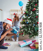 Girlfriend and boyfriend opening christmas gifts. Стоковое фото, фотограф Elnur / Фотобанк Лори