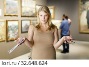 Woman throwing up hands near picture. Стоковое фото, фотограф Яков Филимонов / Фотобанк Лори