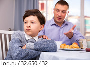 Upset father and offended son arguing in domestic interior. Стоковое фото, фотограф Яков Филимонов / Фотобанк Лори