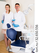 Stomatologist in uniform with his assistent are meeting next client near dental chair. Стоковое фото, фотограф Яков Филимонов / Фотобанк Лори