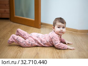 Portrait of Caucasian baby lying on floor in domestic room, creeper. Стоковое фото, фотограф Кекяляйнен Андрей / Фотобанк Лори