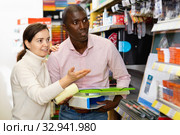 Portrait of male and female customers choosing stationery at store. Стоковое фото, фотограф Яков Филимонов / Фотобанк Лори