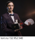 Handsome man showing tricks in the dark. Стоковое фото, фотограф Гурьянов Андрей / Фотобанк Лори