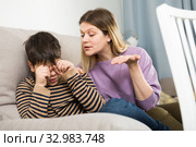 Mother and offended son crying during arguing in domestic interior. Стоковое фото, фотограф Яков Филимонов / Фотобанк Лори