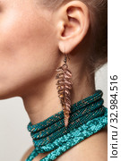 Beautiful woman in collar and galvanic earring in form of fern leaf. Стоковое фото, фотограф Сергей Пристяжнюк (Serg Zastavkin) / Фотобанк Лори
