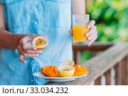 Tasty exotic fruits - ripe passion fruit, mango on breakfast at outdoor restaraunt. Стоковое фото, фотограф Дмитрий Травников / Фотобанк Лори