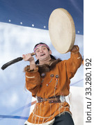 Aborigine dancer in traditional clothes native people expression dancing with tambourine. Concert Koryak Dance Ensemble Mengo (2019 год). Редакционное фото, фотограф А. А. Пирагис / Фотобанк Лори