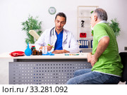 Old man visiting young male doctor gastroenterologist. Стоковое фото, фотограф Elnur / Фотобанк Лори