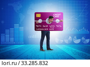 Businessman in credit card burden concept in pillory. Стоковое фото, фотограф Elnur / Фотобанк Лори