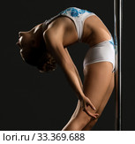 Flexible female dancer leaned to the pylon. Стоковое фото, фотограф Гурьянов Андрей / Фотобанк Лори