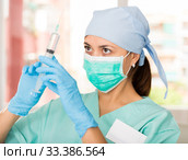 Professional nurse young woman making injection in hospital. Стоковое фото, фотограф Яков Филимонов / Фотобанк Лори