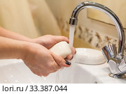 Person soaps hands under a water stream, close up view at Caucasian female arms. Стоковое фото, фотограф Кекяляйнен Андрей / Фотобанк Лори