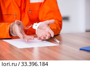 Young man writing letter in provisional detention. Стоковое фото, фотограф Elnur / Фотобанк Лори