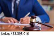 Handsome judge with gavel sitting in courtroom. Стоковое фото, фотограф Elnur / Фотобанк Лори
