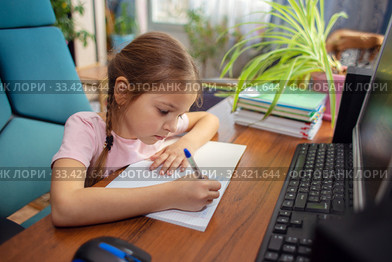 Girl schoolgirl does school homework at home in front of a computer. Стоковое фото, фотограф Екатерина Кузнецова / Фотобанк Лори