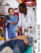 Doctor resuscitating patient with help of defibrillator. Стоковое фото, фотограф Яков Филимонов / Фотобанк Лори