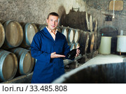 Male winery technician posing with bottle. Стоковое фото, фотограф Яков Филимонов / Фотобанк Лори