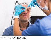 Female doctor is doing injection to patient in skin of face. Стоковое фото, фотограф Яков Филимонов / Фотобанк Лори