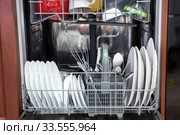 Front view at automatic dishwashing machine full loaded with utensils. Стоковое фото, фотограф Кекяляйнен Андрей / Фотобанк Лори