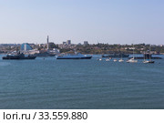 Морской тральщик "Железняков" и "Турбинист" проходят вдоль строя военных кораблей на параде в честь Дня ВМФ в городе-герое Севастополе, Крым (2019 год). Редакционное фото, фотограф Николай Мухорин / Фотобанк Лори
