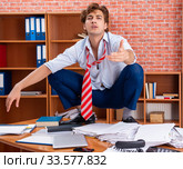 Unhappy businessman sitting in the office. Стоковое фото, фотограф Elnur / Фотобанк Лори