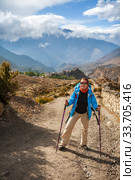 Young woman trekking in the Himalayas, Lower Mustang, Nepal. Стоковое фото, фотограф Юлия Бабкина / Фотобанк Лори