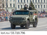 Российский бронированный автомобиль повышенной защищённости «Тайфуненок» КамАЗ-53949 с экипаже едет после парада в честь Дня Победы по Арбату в Москве, вид слева-спереди (2018 год). Редакционное фото, фотограф Малышев Андрей / Фотобанк Лори