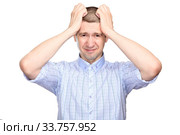 repentant man in a classic blue shirt, short haircut; Grabbed his head with both hands in regret of what had been done; fullface. Isolated. Стоковое фото, фотограф Владимир Арсентьев / Фотобанк Лори