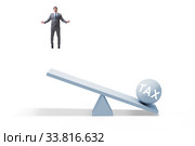 Businessman in tax concept with seesaw. Стоковое фото, фотограф Elnur / Фотобанк Лори