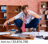 Unhappy businessman sitting in the office. Стоковое фото, фотограф Elnur / Фотобанк Лори
