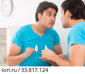 Man trying contact lenses at home. Стоковое фото, фотограф Elnur / Фотобанк Лори