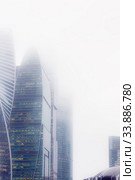 Moscow, Russia - 11/08/2018: Weather. Fog in Moscow. Towers of the skyscrapers of the business center Moscow-City in the evening in the fog. Редакционное фото, фотограф Светлана Евграфова / Фотобанк Лори